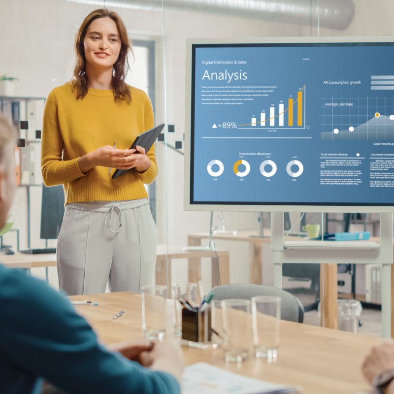 Researcher presenting customer analysis data to colleagues in a meeting
